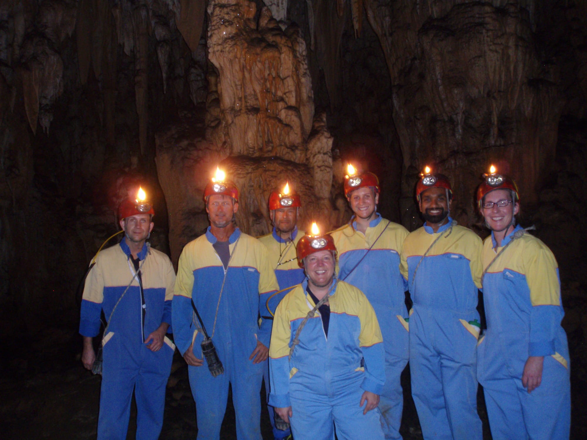 Group exploring a cave with headlamps in the Velebit Mountains, Croatia
